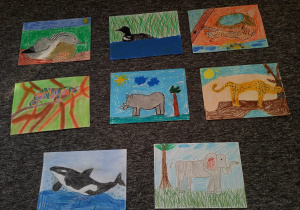 Osiem wyróżnionych rysunków wykonanych przez dzieci przedstawiających dzikie zwierzęta: w tym słoń, nosorożec, dzika kaczka, wieloryb, gepard.