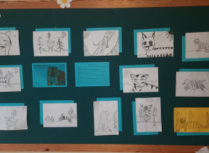Tablica, na której przyczepiono rysunki uczniów przedstawiające tygrysy.