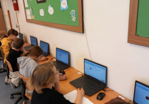 Uczniowie wykonują zadania komputerowe w ramach programu zeszyt.online.